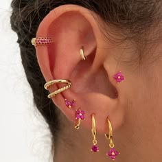 a close up of a person's ear with three different types of piercings