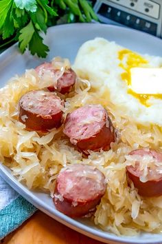 a plate with sausages, mashed potatoes and gravy