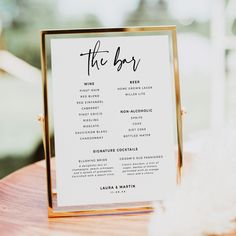 the table plan is on top of a wooden table with white flowers and greenery