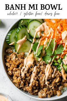 a bowl filled with meat and veggies covered in dressings, sitting on top of a table