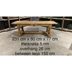 a wooden table sitting on top of a cement floor