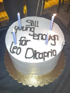 a birthday cake with two candles on it that says still young energy for leo dappo