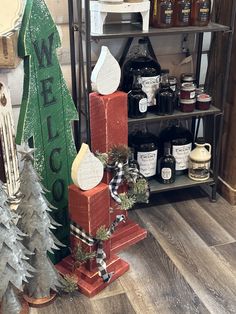 christmas decorations are displayed in front of shelves with candles and other holiday items on them