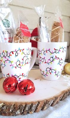 two coffee mugs with christmas decorations on them