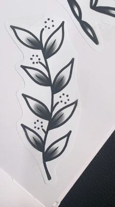 some black and white stickers with leaves on them