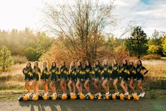 a group of women in cheerleader outfits posing for a photo