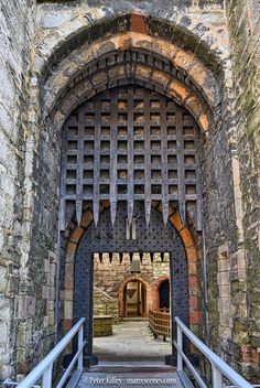 the entrance to an old castle with stone walls