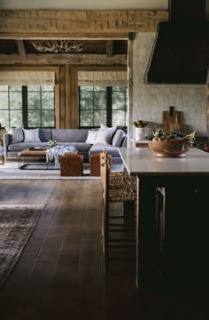 a living room filled with furniture next to a kitchen