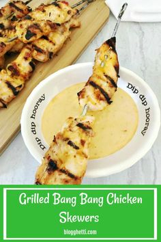 grilled bang bang chicken skewers on a white plate