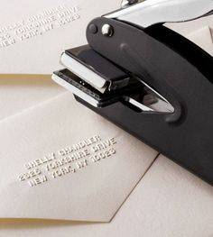 several envelopes with some type of stapler on top of one that has writing on it