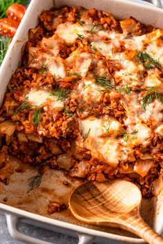 a casserole dish with meat and vegetables in it, topped with parmesan cheese