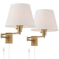 two lamps on the wall with white shades