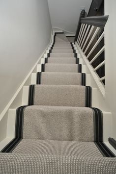 a set of stairs with black and white carpet