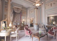 a living room filled with furniture and a chandelier