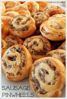 sausage pinwheels on a white plate with the words sausage pinwheels above it