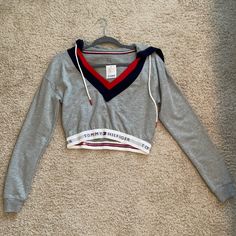 Urban Outfitters Tommy Hilfiger Grey Cropped Sweatshirt. Nwt, Never Worn. Excellent Condition. Sporty Long Sleeve Tommy Hilfiger Top, Tommy Hilfiger Sporty Long Sleeve Tops, Trendy Tommy Hilfiger Tops For Fall, Tommy Hilfiger Hoodie Woman, Tommy Hilfiger Outfits Women, Tommy Hilfiger Outfits, Hilfiger Outfits, Tommy Hilfiger Crop Top, Mesh Hoodie