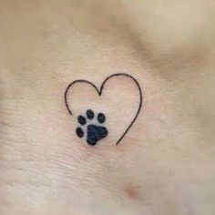 a small heart shaped paw print on the side of a woman's stomach, with an image of a dog's paw in it