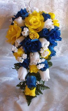 a bridal bouquet with blue, yellow and white flowers