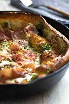 a close up of a pizza in a pan on a table