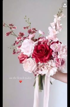 a person holding a bouquet of flowers in their hand