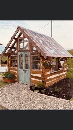 a small wooden cabin with a metal roof