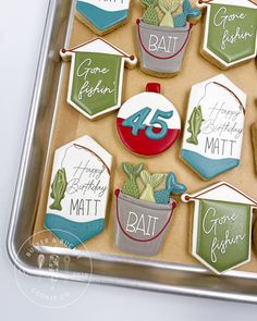 decorated cookies in the shape of hats and numbers are on a cookie sheet that says happy birthday matt