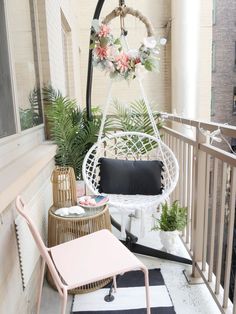 the balcony is decorated with plants and wicker furniture, including a hammock chair