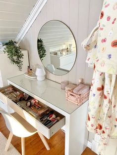 a dressing table with a mirror, stool and other items on it in a room