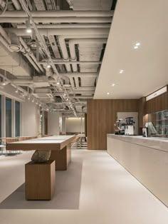 an open kitchen with lots of counter space and lights on the ceiling, along with large windows