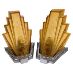 pair of art deco glass bookends in gold and silver metal with geometric design