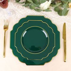 a green plate sitting on top of a table next to a knife, fork and spoon