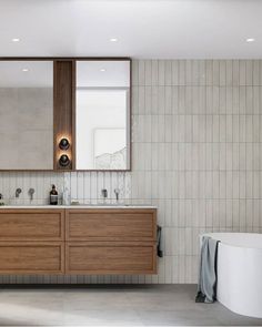 a bathroom with two sinks and a bathtub