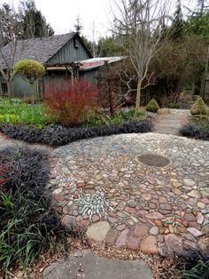 a stone path in the middle of a garden