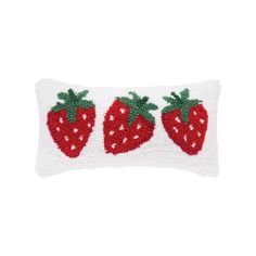 a white pillow with three strawberries on the front and one strawberry on the back