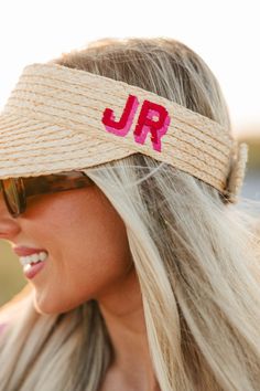 This stylish straw visor makes the perfect accessory to improve your look for any sunny outings. Personalize it with your preferred colors and monogram for a unique touch that's sure to make a statement. You'll be able to easily recognize yours among the rest! Enjoy the sunshine in style. Hat Details: Beige straw Visor 4" Brim Adjustable Velcro back Summer Vacation Straw Visor, Summer Beach Visor, Trendy Embroidered Visor Hats, Beach Visor Hat With Embroidered Logo, Summer Embroidered Visor Hat, Beach Vacation Accessories, Straw Visor, Floppy Beach Hat, Straw Hat Beach