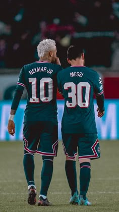 two soccer players standing next to each other