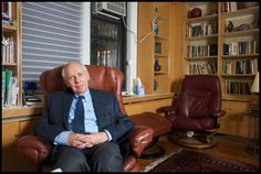 an older man sitting in a leather chair