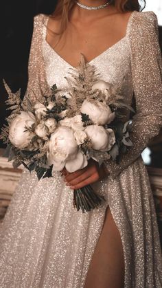 a woman in a white dress holding a bouquet