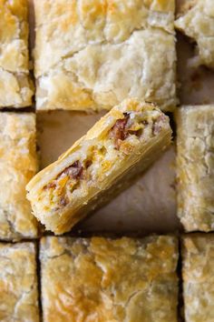 some food is laying on top of each other in the shape of squares and rectangles