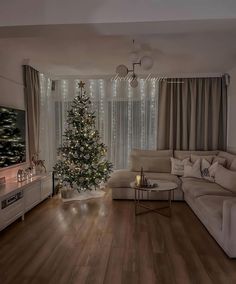 a living room filled with furniture and a christmas tree