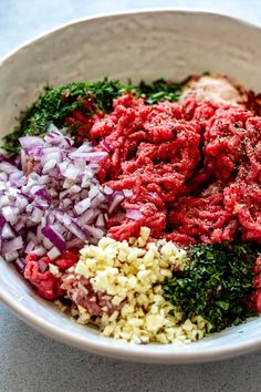 a white bowl filled with meat and vegetables