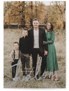 a family posing for a photo in the grass