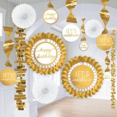 gold and white decorations hanging from the ceiling