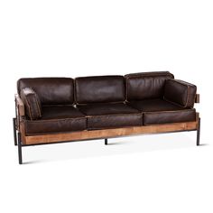 a brown leather couch sitting on top of a wooden frame