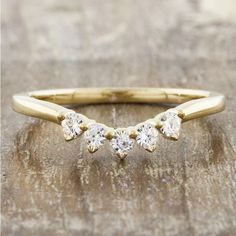 three stone diamond ring on wooden surface