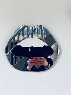 a woman taking a selfie in front of a mirror with an umbrella on it