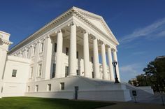 a large white building with columns on the front and side of it's sides