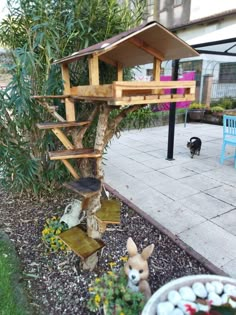 a dog is standing in front of a tree house