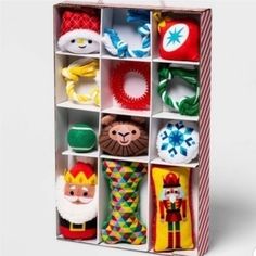 an open cardboard box filled with different types of stuffed animals and toys in it's compartments