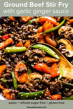 a skillet filled with ground beef, peppers and carrots on top of a table